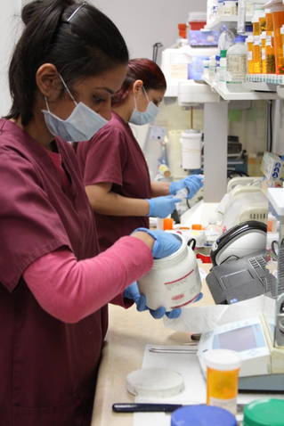 Two of our technicians working in our lab